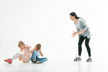 Image showing Angry mother scolding her son in living room at home