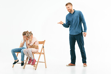 Image showing Angry father scolding his son in living room at home