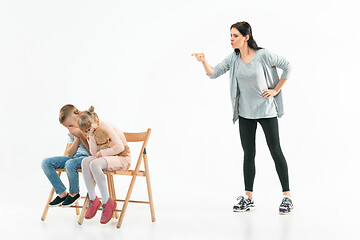 Image showing Angry mother scolding her son in living room at home