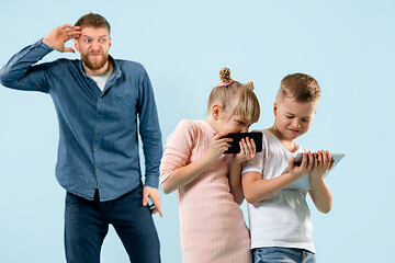 Image showing Angry father scolding his son in living room at home