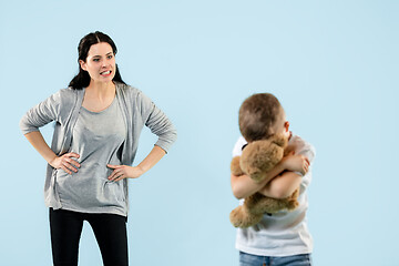 Image showing Angry mother scolding her son in living room at home