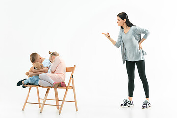 Image showing Angry mother scolding her son in living room at home