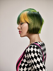 Image showing Close-up indoor portrait of lovely girl with colorful hair. Studio shot of graceful young woman with short haircut