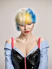 Image showing Close-up indoor portrait of lovely girl with blonde hair. Studio shot of graceful young woman with short haircut