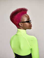 Image showing Close-up indoor portrait of lovely girl with colorful hair. Studio shot of graceful young woman with long haircut