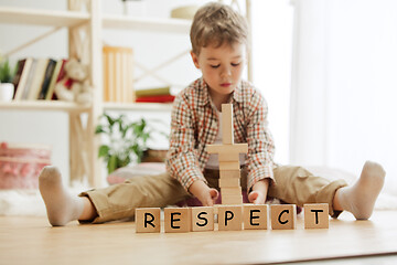 Image showing Wooden cubes with word RESPECT in hands of little boy