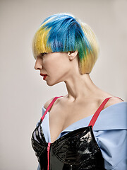 Image showing Close-up indoor portrait of lovely girl with blonde hair. Studio shot of graceful young woman with short haircut