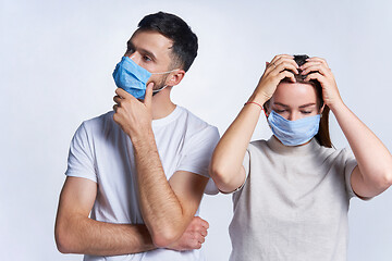 Image showing Young couple wearing medicine masks