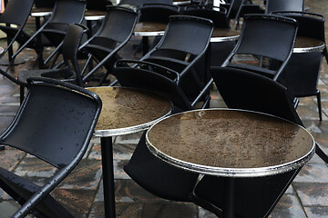 Image showing empty coffee tables in the rain 