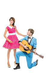 Image showing doll looking boy and girl with guitar