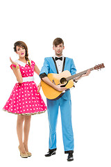 Image showing doll looking boy and girl with guitar