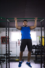 Image showing man doing pull ups on the horizontal bar