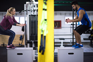 Image showing athletes working out  jumping on fit box