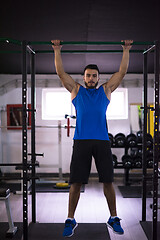 Image showing man doing pull ups on the horizontal bar