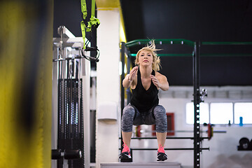 Image showing woman working out  jumping on fit box