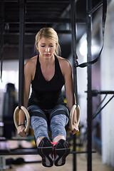 Image showing woman working out pull ups with gymnastic rings