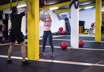 Image showing young athletes couple working out with medical ball