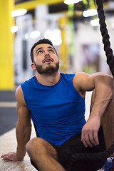 Image showing man relaxing before rope climbing