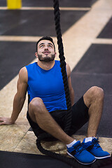 Image showing man relaxing before rope climbing