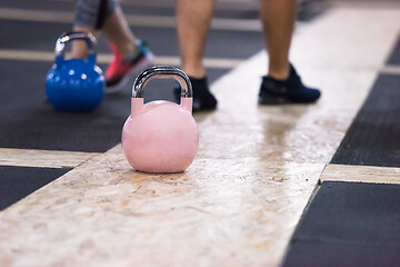 Image showing athletes doing exercises with kettlebells