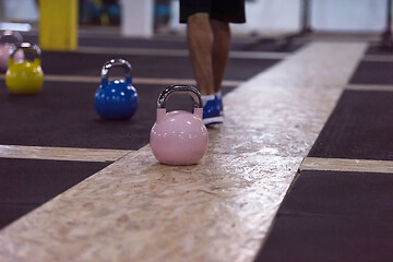 Image showing athletes doing exercises with kettlebells