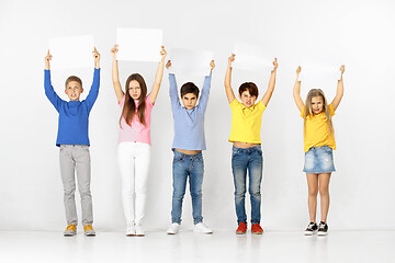 Image showing Group of children with a white banners isolated in white