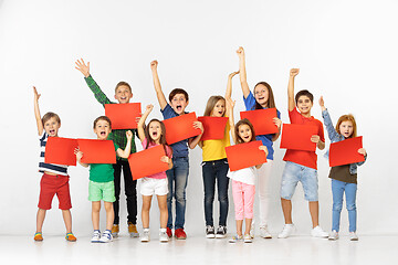 Image showing Group of children with a red banners isolated in white