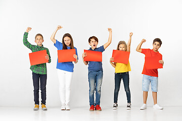 Image showing Group of children with red banners isolated in white