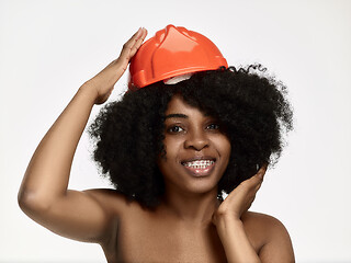 Image showing Portrait of confident female worker in orange helmet