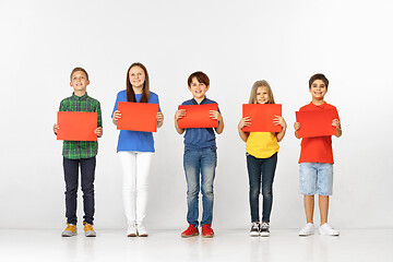 Image showing Group of children with red banners isolated in white