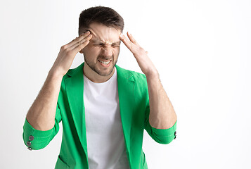 Image showing Man having headache. Isolated over gray background.