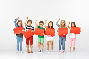 Image showing Group of children with red banners isolated in white