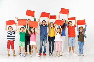 Image showing Group of children with a red banners isolated in white