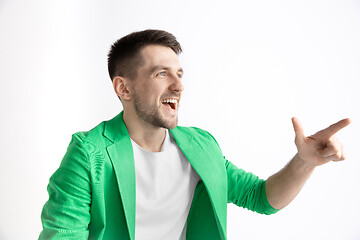 Image showing The happy businessman standing and smiling against gray background.