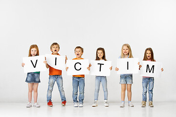 Image showing Victim. Group of children with a banners isolated in white