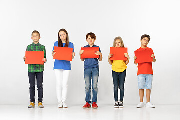 Image showing Group of children with red banners isolated in white