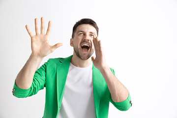 Image showing Young casual man shouting. Shout.