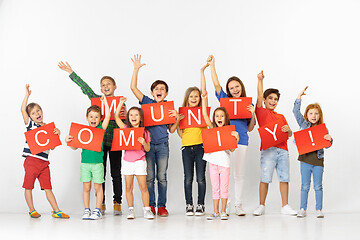 Image showing Community. Group of children with a red banners isolated in white