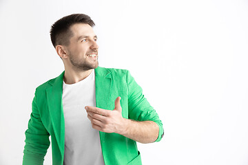 Image showing The happy businessman standing and smiling against gray background.