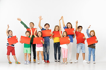 Image showing Group of children with a red banners isolated in white