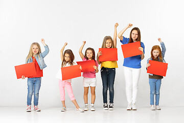 Image showing Group of children with red banners isolated in white