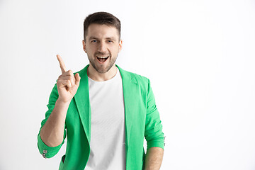 Image showing The happy businessman standing and smiling against gray background.