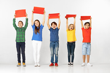 Image showing Group of children with red banners isolated in white