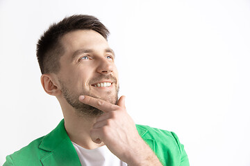 Image showing Young dreaming man isolated on white background looking at something