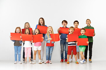 Image showing Group of children with a red banners isolated in white