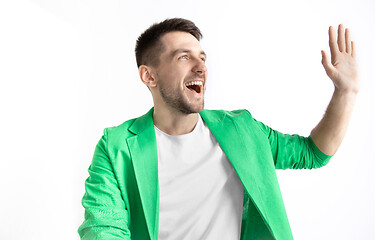 Image showing The happy businessman standing and smiling against gray background.