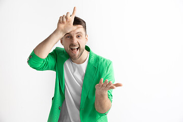 Image showing Losers go home. Portrait of happy guy showing loser sign over forehead