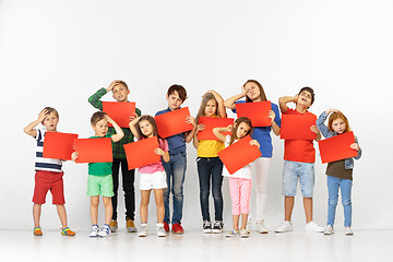 Image showing Group of children with red banners isolated in white