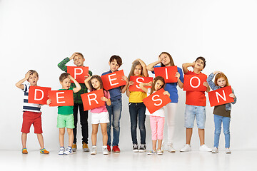 Image showing Depression kills your character. Group of children with red banners isolated in white