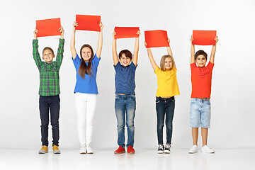 Image showing Group of children with red banners isolated in white